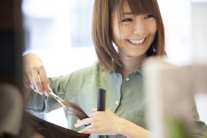 Hairdresser is cutting hair